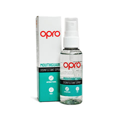 A bottle of OPRO mouthguard disinfectant spray with its packaging box. The bottle is transparent with a white spray nozzle and the box has 'OPRO' branding along with the text 'MOUTHGUARD DISINFECTANT SPRAY'.