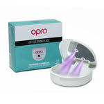 A UV cleaning case for mouthguards, open with UV lights active, alongside its packaging box which has 'OPRO' branding.